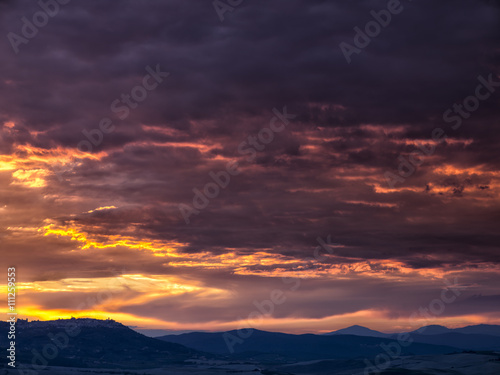 sunset over the mountain range in tuscany