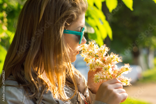 .woman smelling a flower