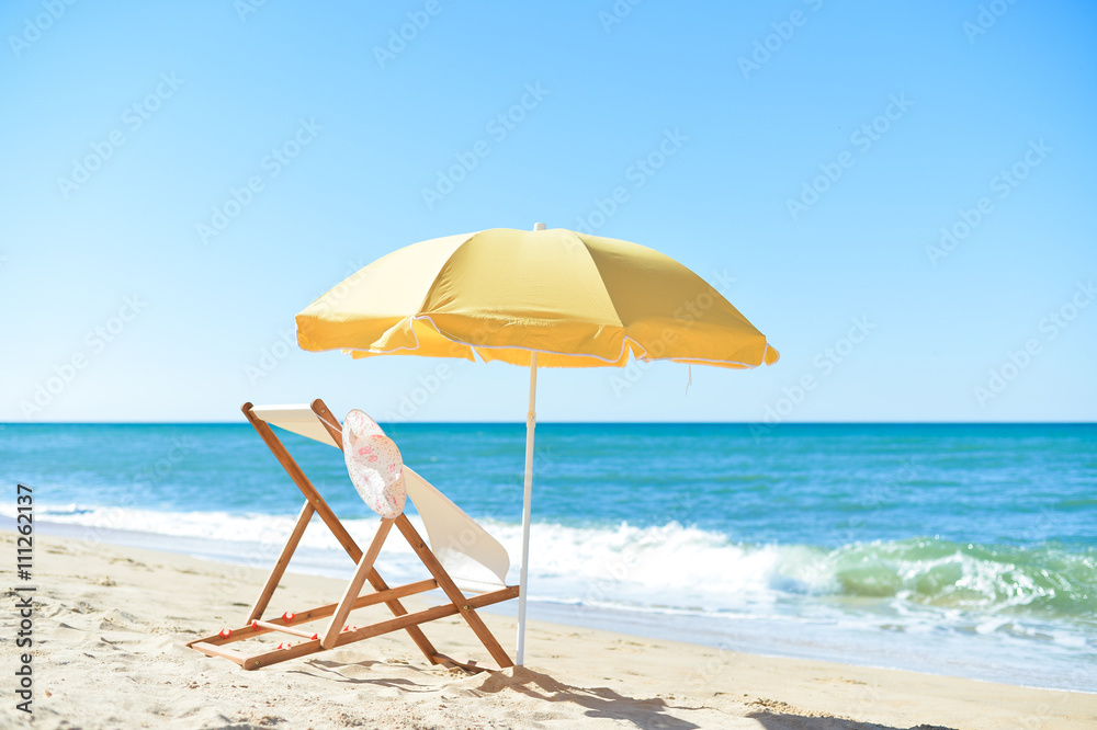 Female hat, chair and umbrella on stunning tropical beach background vacation 