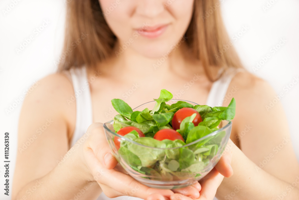 A young beautiful woman with a bowl of salad A young beautiful woman with a bowl of salad