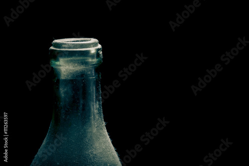 Ancient dust bottle on dark background. Selective focus. Shallow