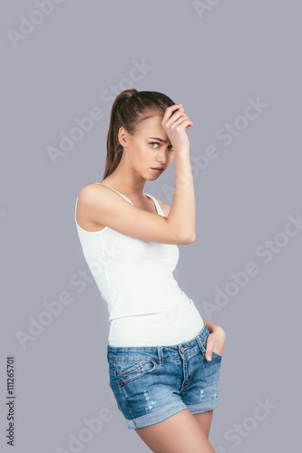 Portrait of a sad girl on a gray background © Artem Varnitsin
