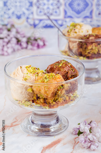 Baklava with ice cream on marble background.  Turkish arabic cuisine. Ramadan food. Selective focus