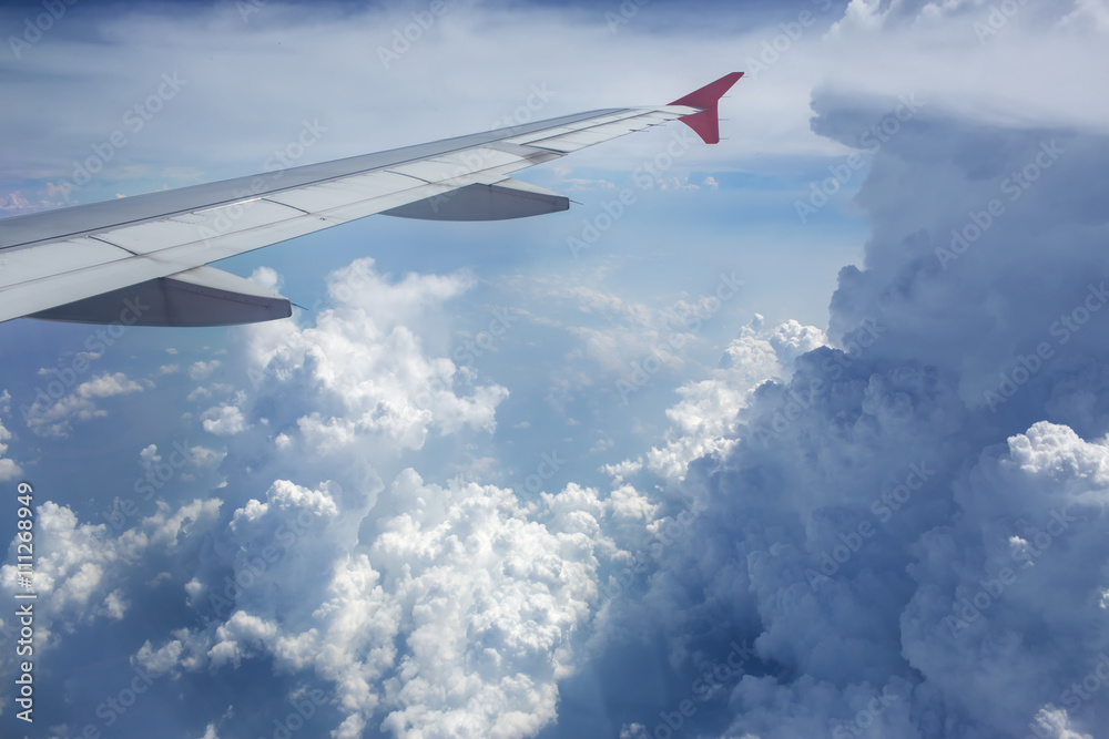 Above the clouds.Wing aircraft in the sky under earth of Bali,Indonesia Above the clouds.Wing aircraft in the sky under earth of Bali,Indonesia