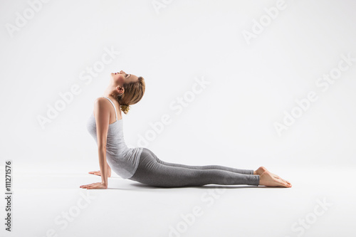 Bild auf Leinwand Pretty sporty blonde in doing yoga on white background
