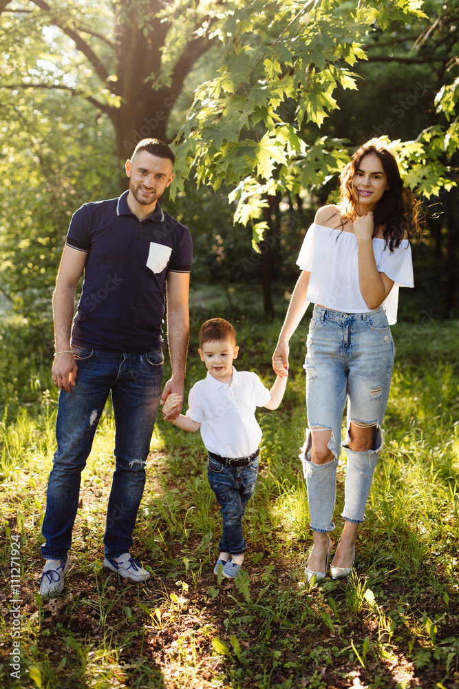 Fototapeta premium Young family spending holiday in park