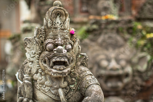 Schilderij op canvas Traditional demon guard statue carved in stone in Bali island.