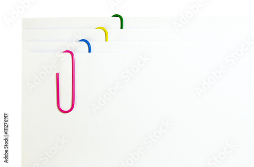 white paper with colored paper clips