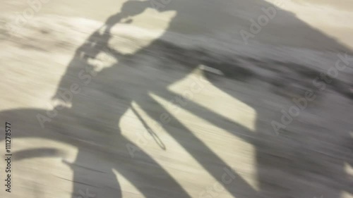 shadow of a cyclist on the road 