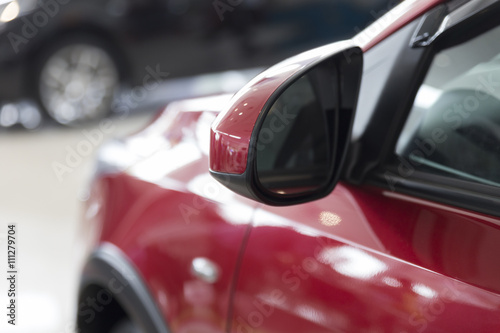 rear mirror of red car