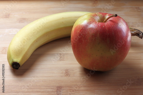 Apple and banana on a wooden table