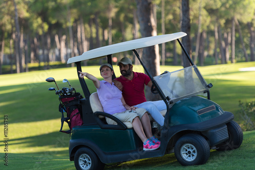 couple in buggy on golf course