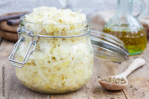 Homemade sauerkraut with cumin in a glass jar  photo