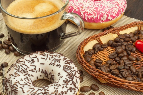 Fresh hot coffee and fresh donuts. Traditional sweets with coffee. Calorie junk food. Fresh unhealthy breakfast. 