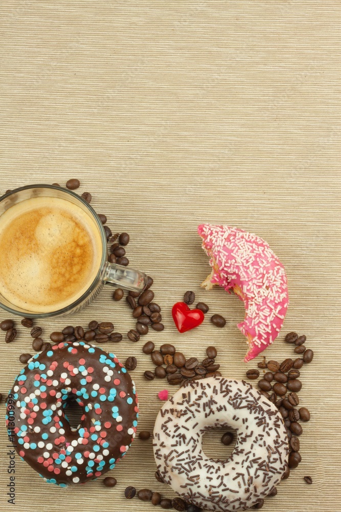 Fresh hot coffee and fresh donuts. Traditional sweets with coffee. Calorie junk food. Fresh unhealthy breakfast.
