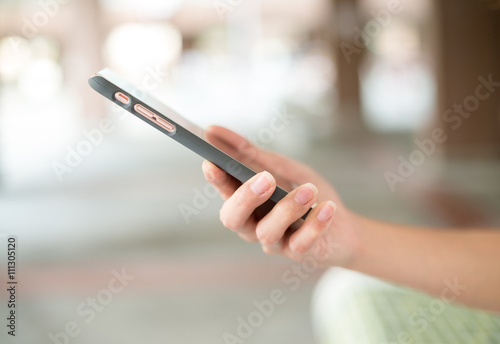 Woman sending sms on smart phone