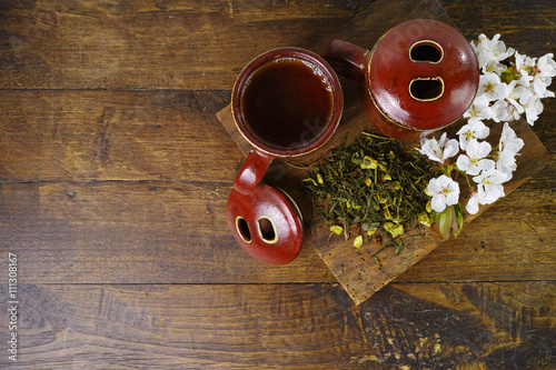 Japan's tea cups with green tea and sakura flowers photo