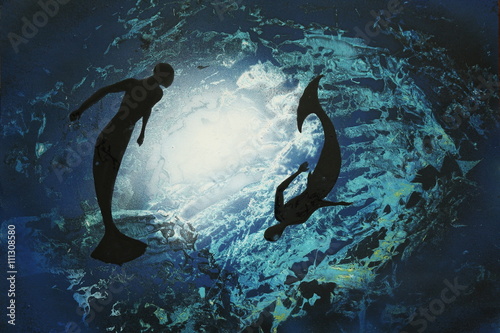 Two mermaids circling underwater. photo