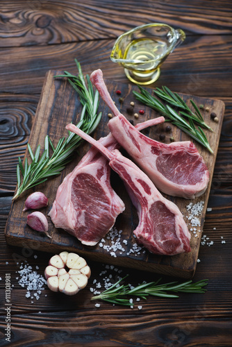 Raw lamb shoulder rack steaks in a rustic wooden setting
