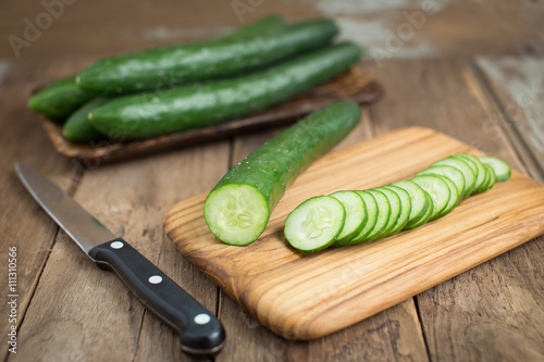 Cucumber on wood background.