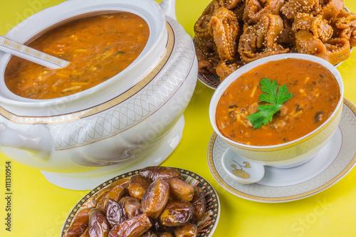 Bowl of Moroccan harira soup,chebakia, dates for iftar