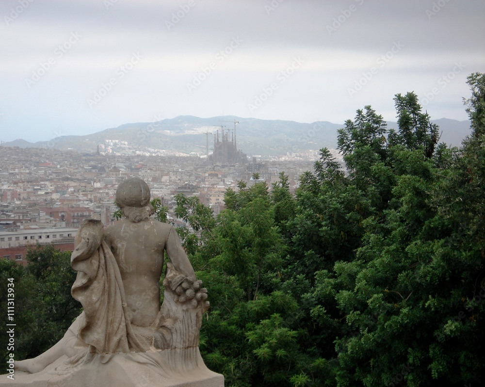 Statue looking towards Barcelona clouds