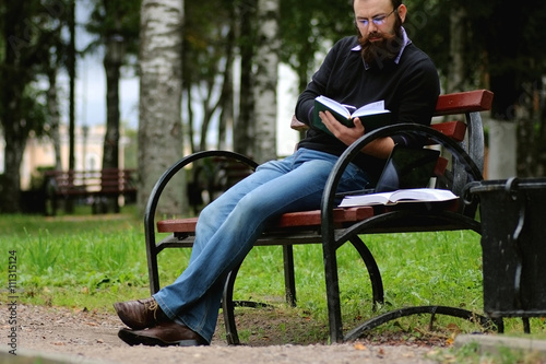 man reading books in the park