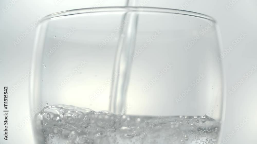 Pouring transparent soda water in a glass. Slow motion stock footage shot in 240 fps. Pouring transparent soda water in a glass. Slow motion stock footage shot in 240 fps.