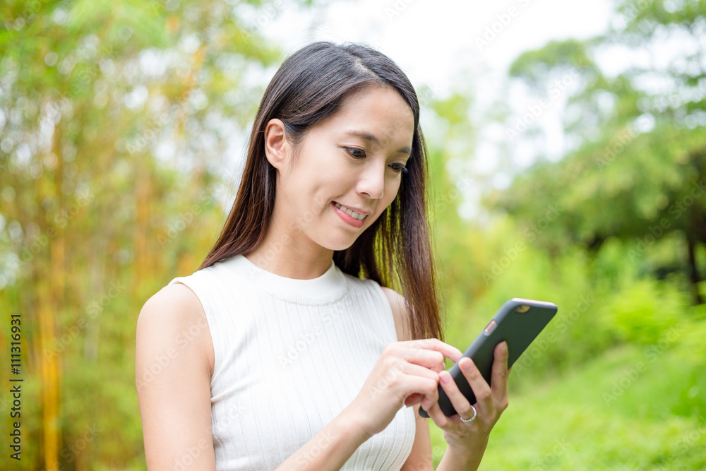 Woman sending sms on cellphone