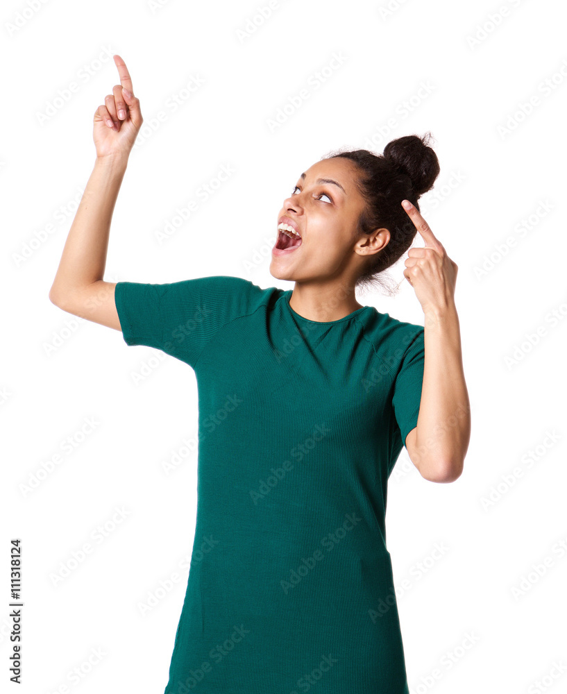 Excited young woman pointing up and laughing Excited young woman pointing up and laughing