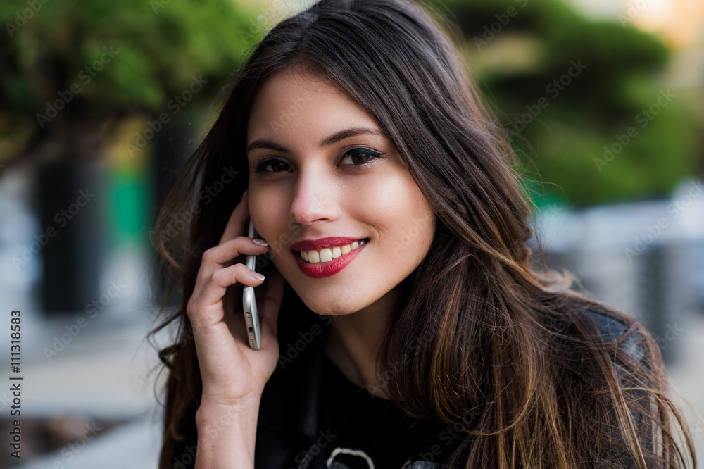 Portrait of a beautiful woman with perfect white smile talking on the mobile phone outdoor Portrait of a beautiful woman with perfect white smile talking on the mobile phone outdoor