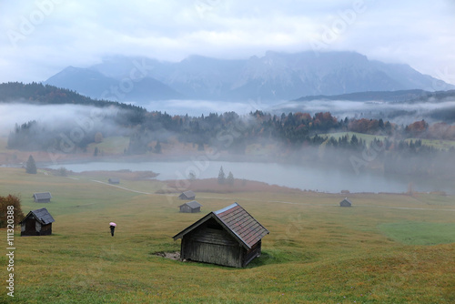 Foggy morning scenery of Lake Geroldsee in autumn, an alpine lake between Garmisch-Partenkirchen and Mittenwald with Karwendel mountains in the background, Gerold, Bavaria, Germany