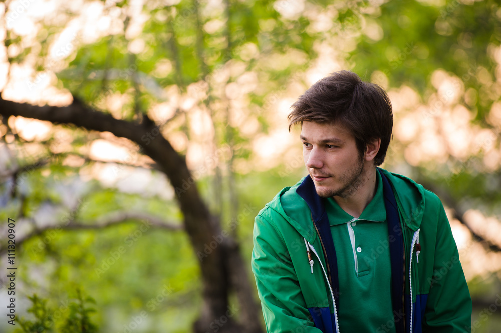 Photo of a young man using smartphone at sunset Photo of a young man using smartphone at sunset