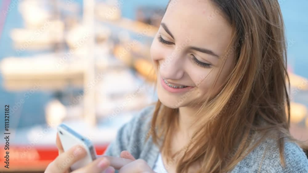 Female using her mobile phone. Female using her mobile phone.