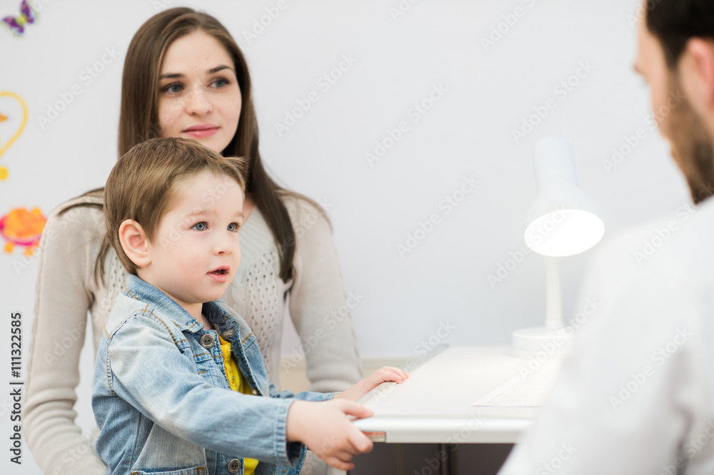 Pediatrician talking to mother and child at office Pediatrician talking to mother and child at office