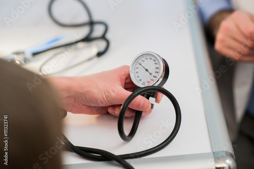Doctor is measuring blood pressure with a tonometer