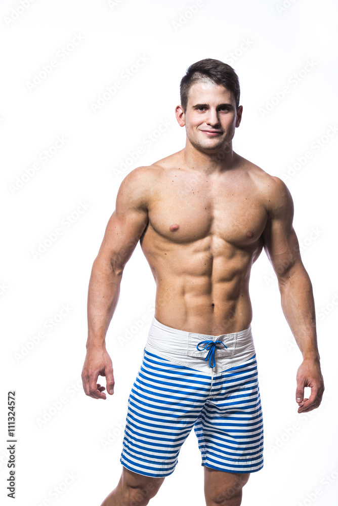 Sexy athletic man showing muscular body and sixpack abs, isolated over white background. Strong male nacked torso