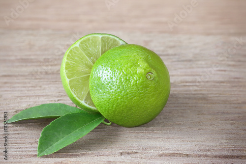  limes  slice and leaves on wooden board