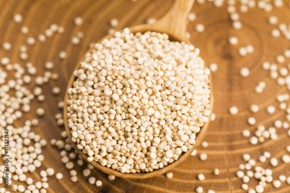 White quinoa seeds on a wooden background White quinoa seeds on a wooden background
