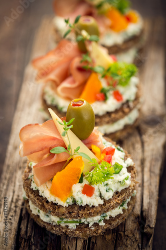 Canapes with prosciutto and cheese 