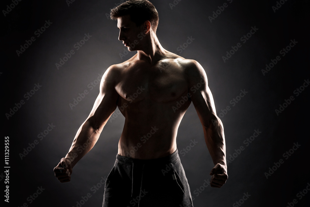 Naklejka premium Sexy shirtless bodybuilder posing,