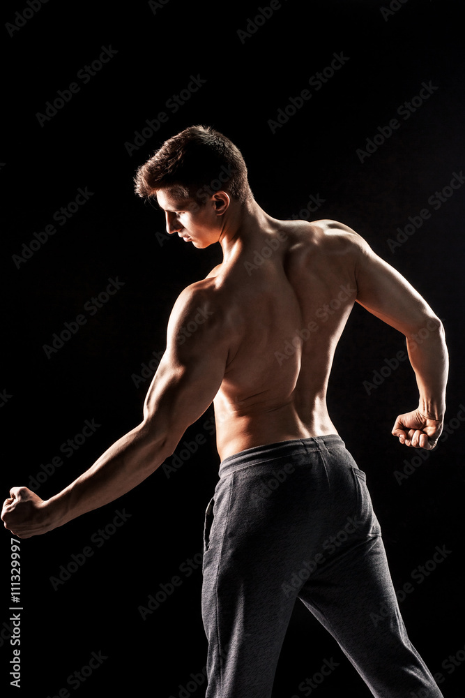 Strong man showing perfect abs, houlders, biceps, triceps and ch Strong man showing perfect abs, houlders, biceps, triceps and ch
