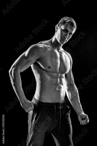 Strong man showing perfect abs, houlders, biceps, triceps and ch
