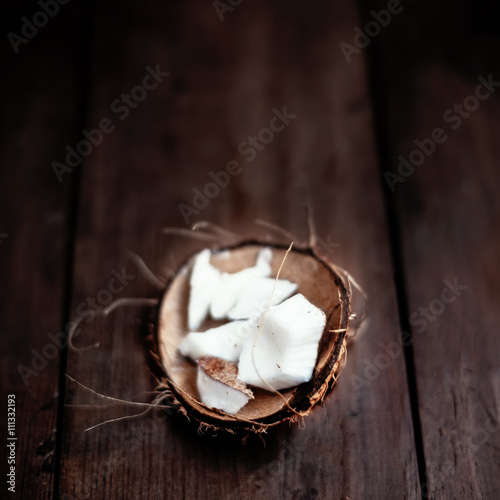 Coconut  pieces / close up of a coconut on a wooden background w