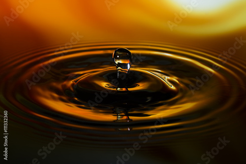 Close-up of water drop on yellow orange background