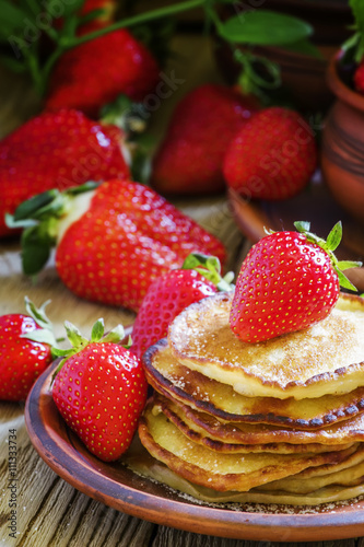 Homemade delicious pancakes with fresh strawberries, vintage woo