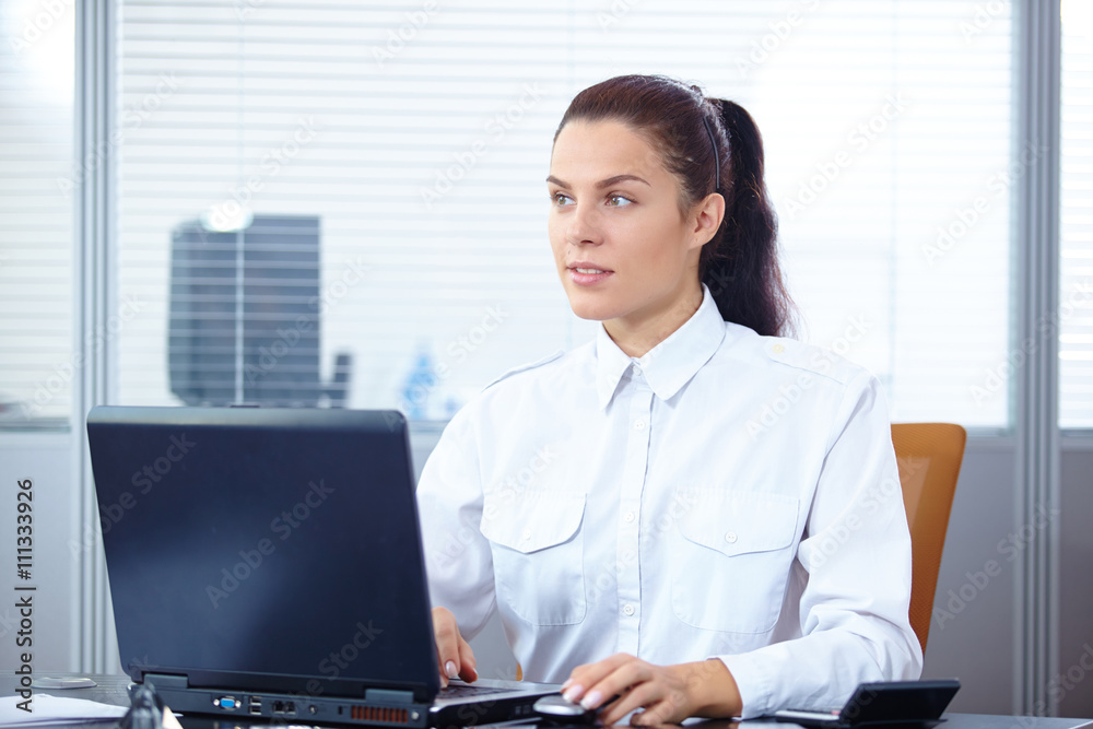 Young businesswoman sitting at workplace Young businesswoman sitting at workplace