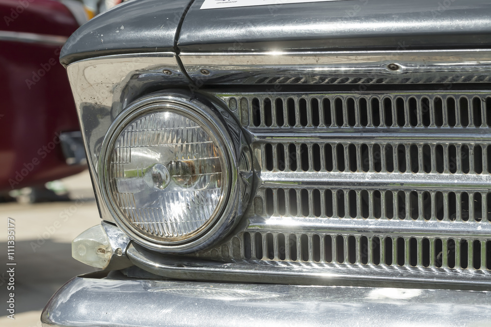 headlight and radiator front view of a retro car
