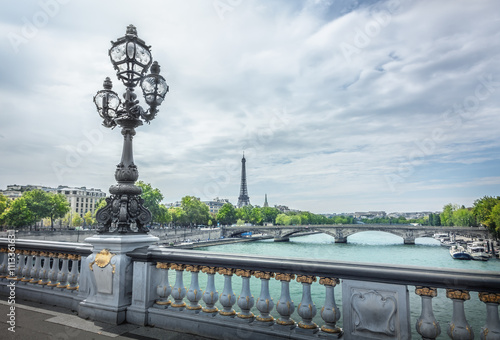 View on Seine river and Eiffel Tower from Alexander III bridge in Paris, France.