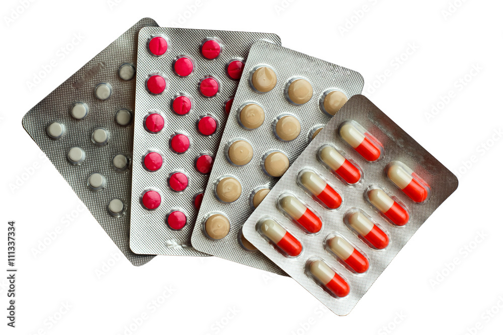 Packs of pills isolated on white. stack of four different multic Packs of pills isolated on white. stack of four different multic